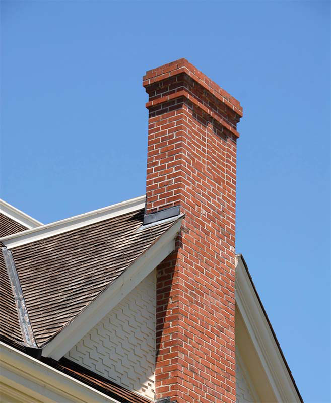 Top Hat & Tails Chimney - Stock image of chimney red brick chimney
